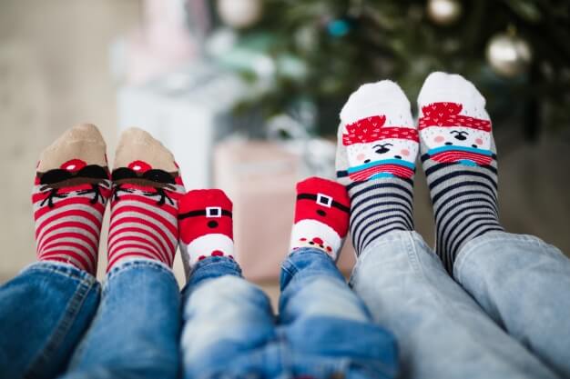 three pairs of socks with christmas printed designs